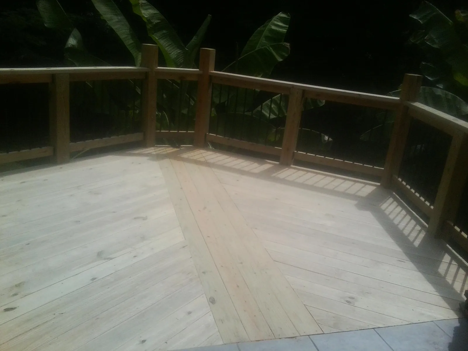 New wood deck and railing built off the back of a home in Middletown